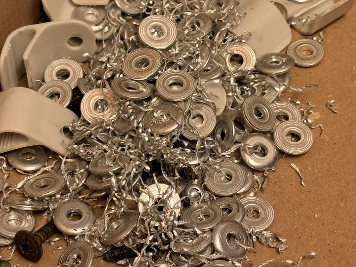 The harvest: drilled-out rivets, aluminium shavings, screws and clips.