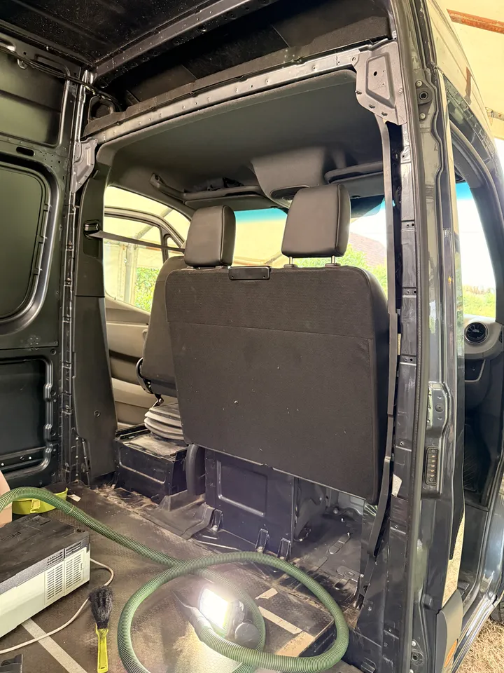 Behind the seats, where all the stripping dust had quietly collected.