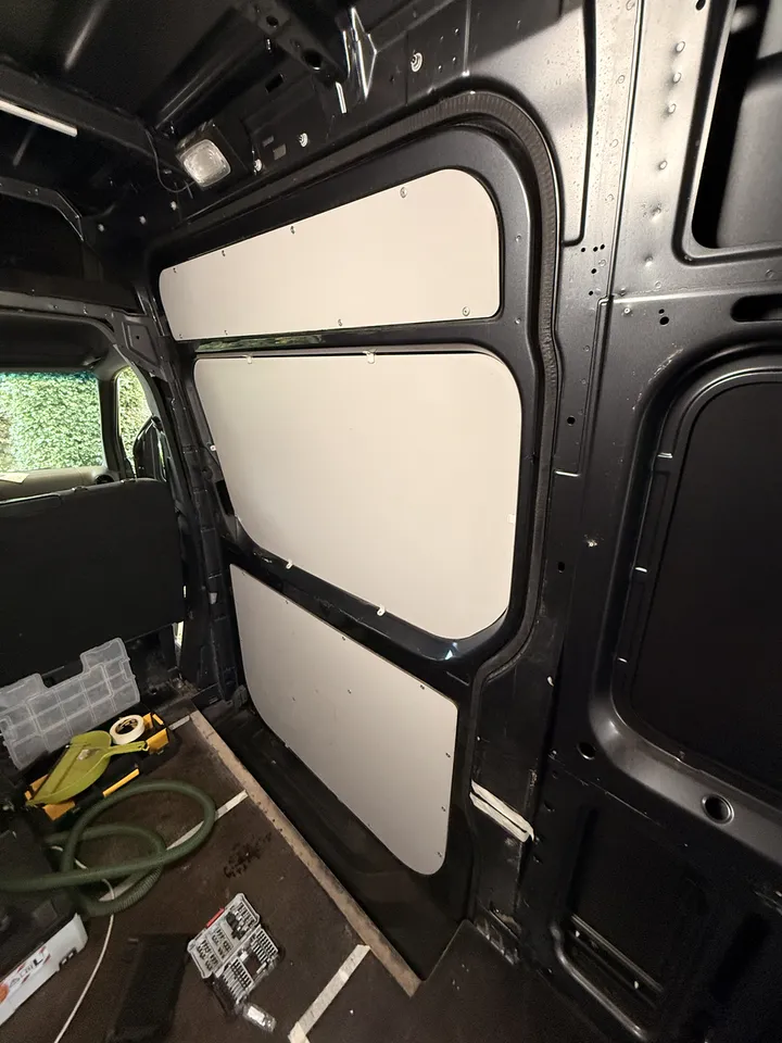 The sliding door, still wearing its factory panels. The last lining left in the van.