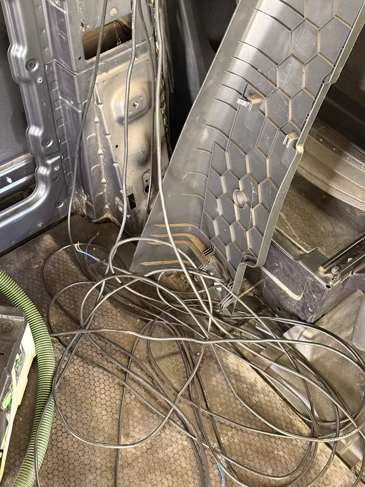 On the cab floor: the cable I pulled out, with the honeycomb back of the pillar trim leaning in the middle of it.