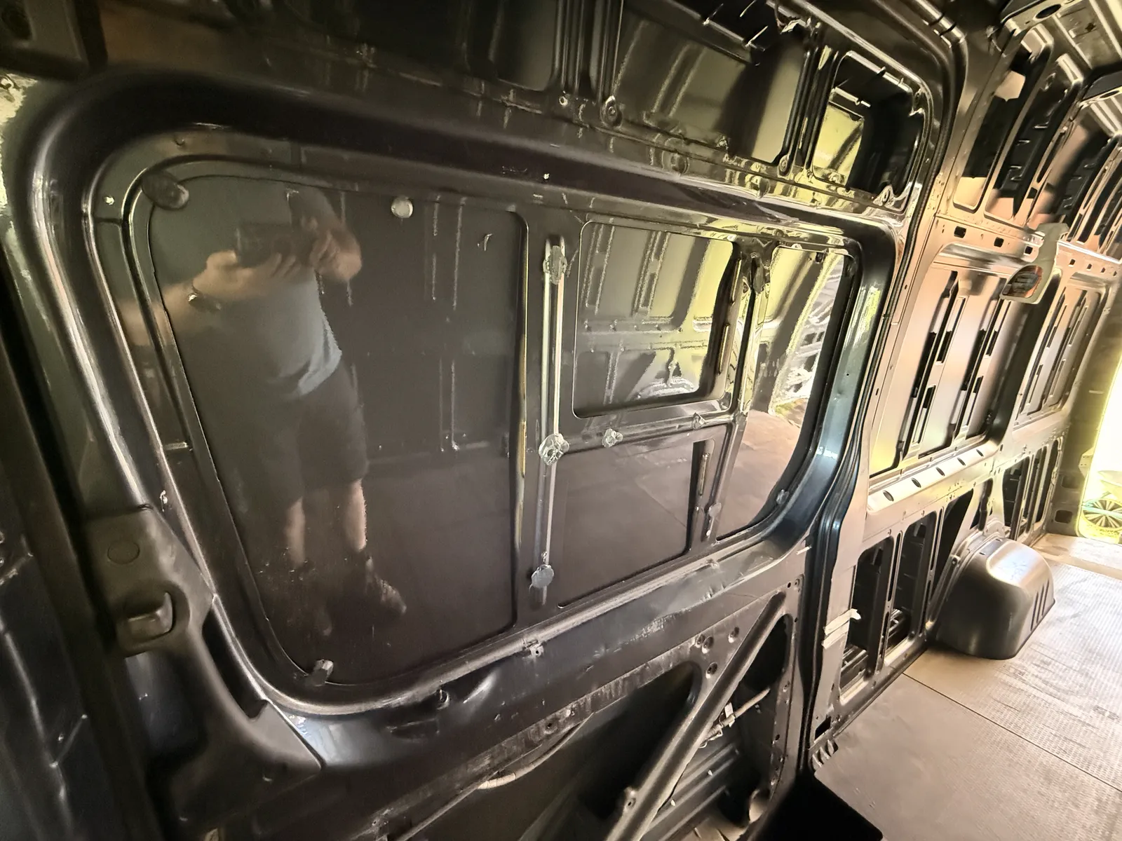 The stripped sliding door seen from inside, with the blanked window recesses pressed into the outer skin