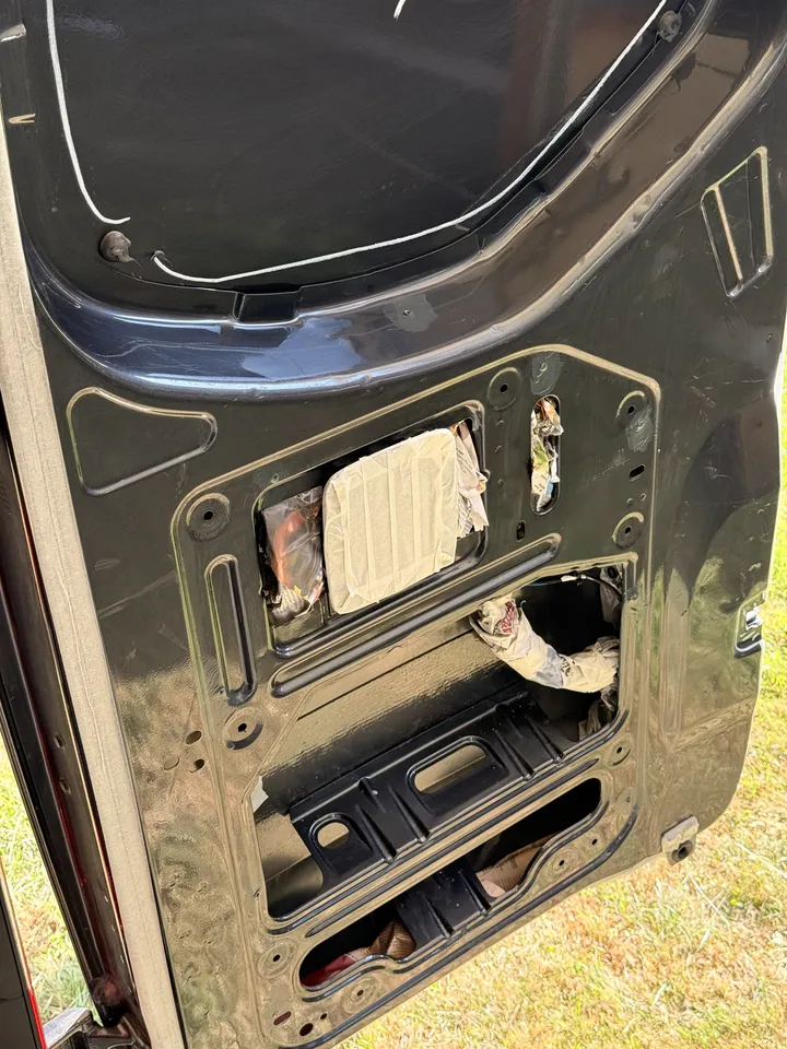 The same trick inside the rear door. Every opening stuffed before anything gets sprayed.