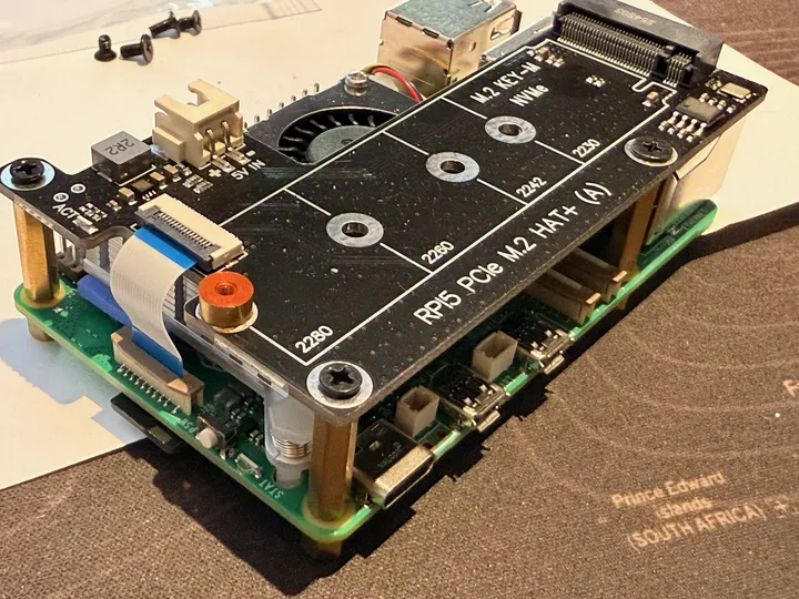 A Raspberry Pi 5 with an M.2 HAT, waiting on the desk