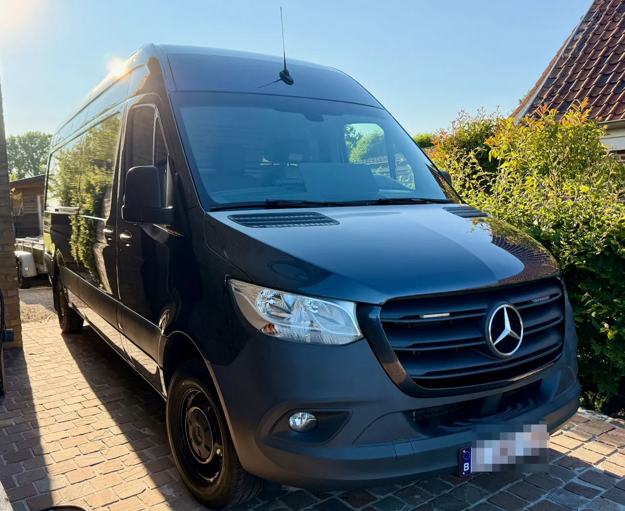 The empty Mercedes Sprinter parked on the driveway, just driven home